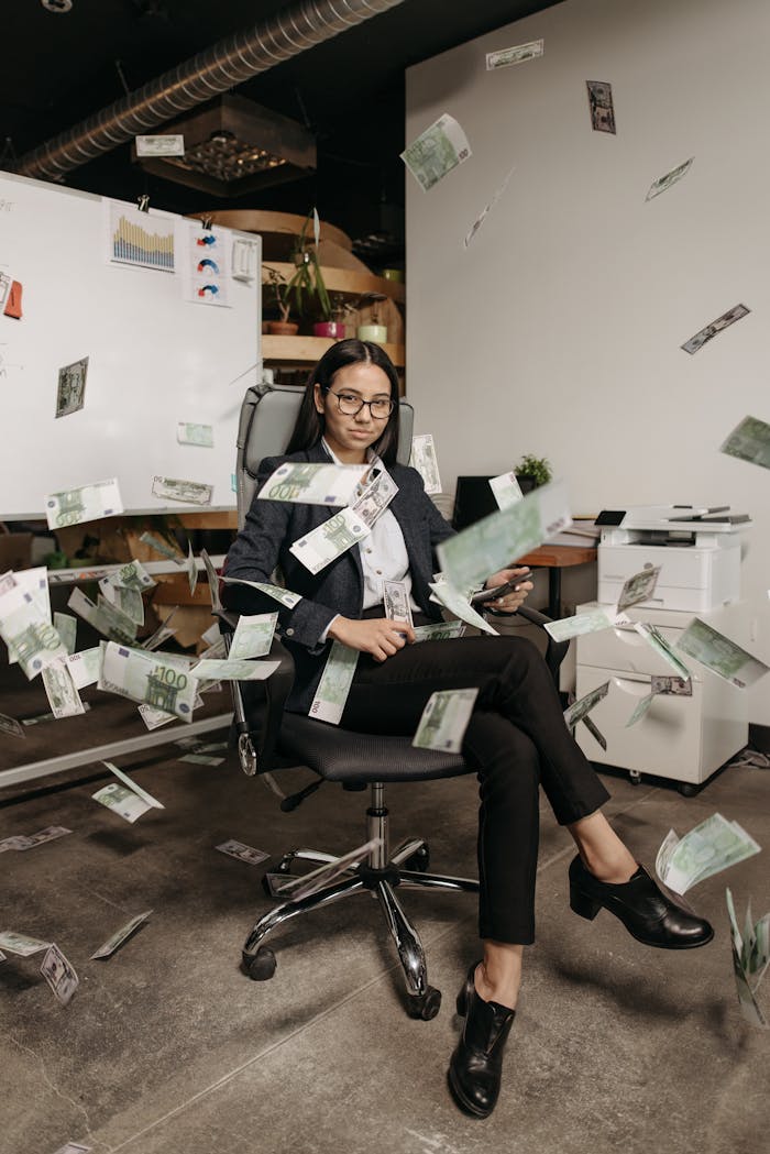 why-choose-us Businesswoman in modern office with falling cash, symbolizing financial success.