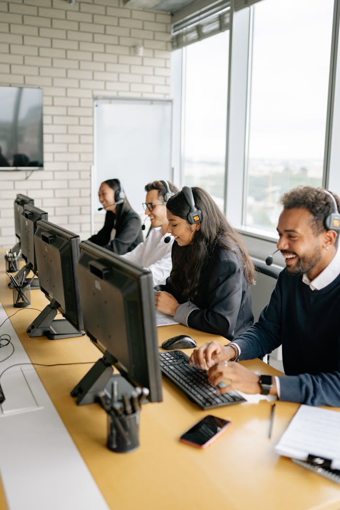 gallery-2 A diverse group of call center employees working together at desks in a modern office.